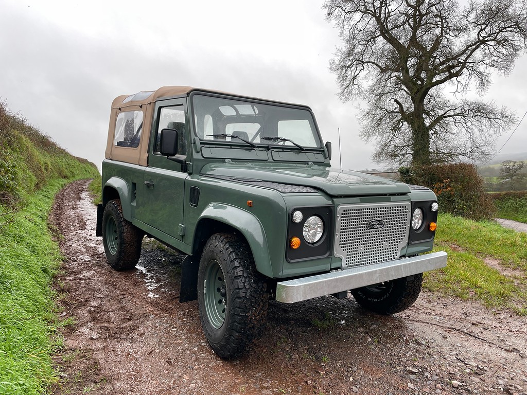 TATC Land Rover Defender 90 Green Soft Top on hill